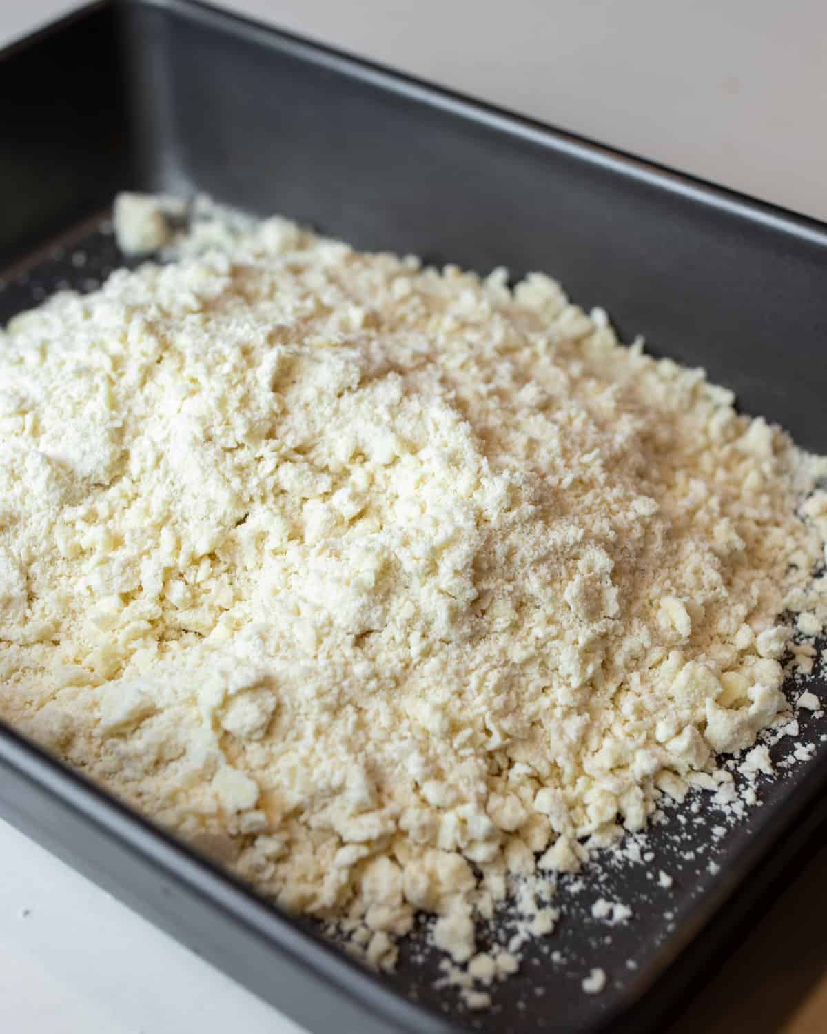 Shortbread dough in a baking pan.